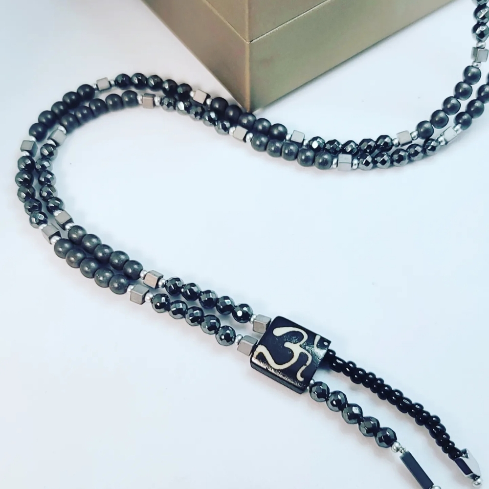 Hematite Om charm necklace 6 mm